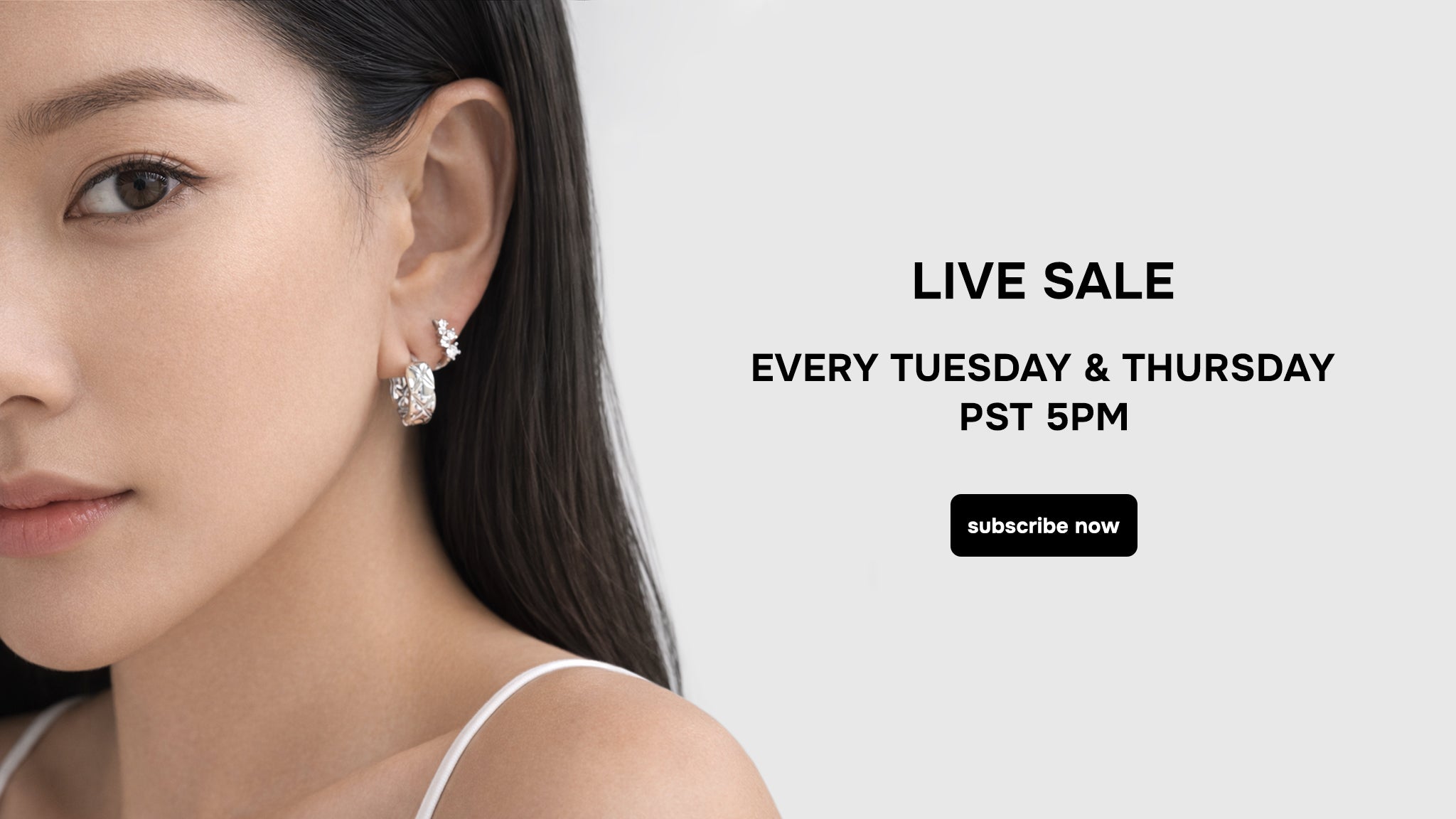 Close-up of a model wearing minimalist silver earrings from myEdzy Las Vegas, clean and modern jewelry aesthetic.