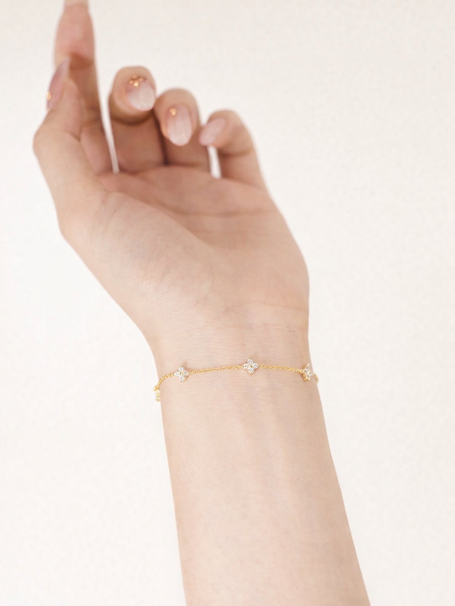 Evie 18K gold plated floral crystal bracelet on wrist by myEdzy