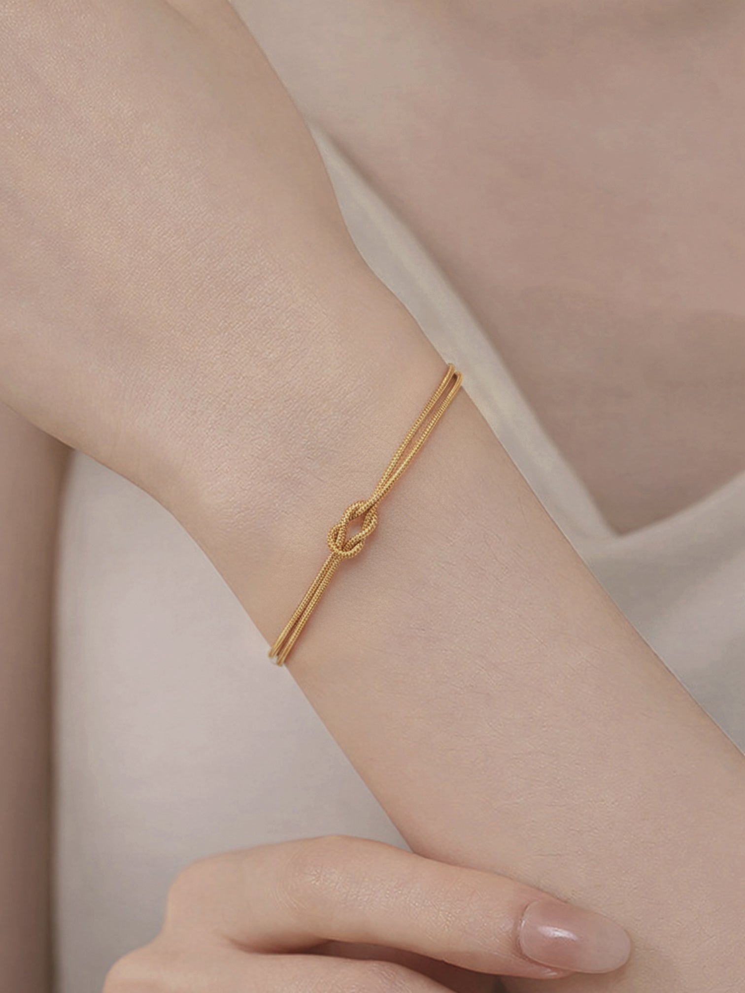 Tate gold plated knot bracelet worn on wrist, adjustable minimalist chain bracelet by myEdzy