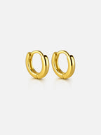 Hailey gold huggie hoop earrings with a smooth polished finish, minimal everyday hoops designed for stacking or wearing solo | myEdzy