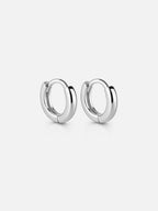 Hailey silver huggie hoop earrings with a smooth polished finish, minimal everyday hoops designed for stacking or wearing solo | myEdzy