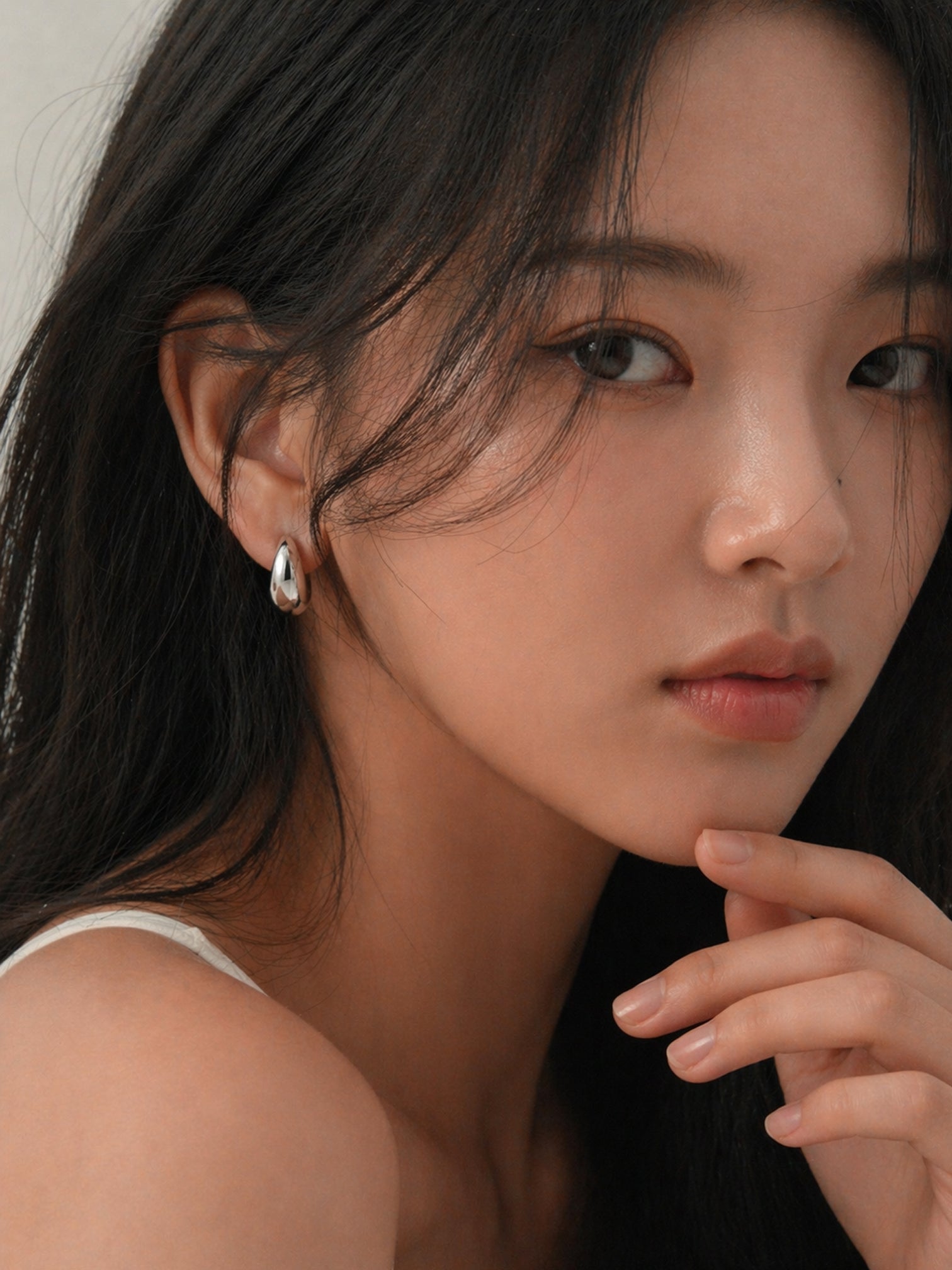 Chunky huggie hoop earrings silver thick mini hoops minimalist bold statement hypoallergenic everyday jewelry myEdzy model portrait