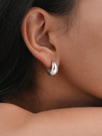 Silver chunky huggie hoop earrings thick mini hoops minimalist bold statement hypoallergenic everyday jewelry myEdzy close up ear