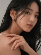 18k gold chunky huggie hoop earrings thick mini hoops minimalist bold statement hypoallergenic everyday jewelry myEdzy model portrait
