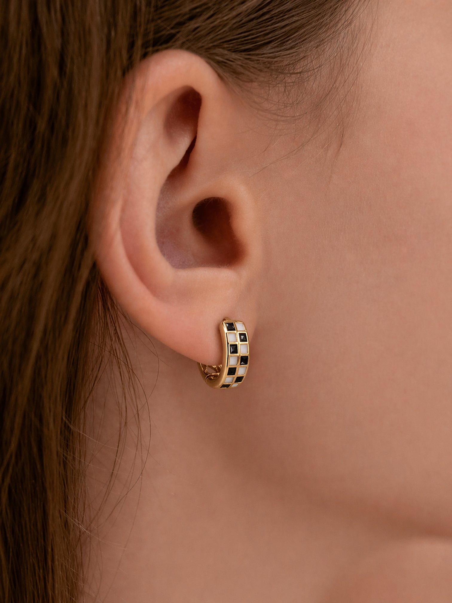 18k gold black white checker huggie hoop earrings enamel chunky mini hoops bold minimalist statement jewelry myEdzy close up ear