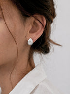 Brushed dome hoop earrings chunky minimalist huggie style bold statement hypoallergenic everyday jewelry myEdzy close up ear
