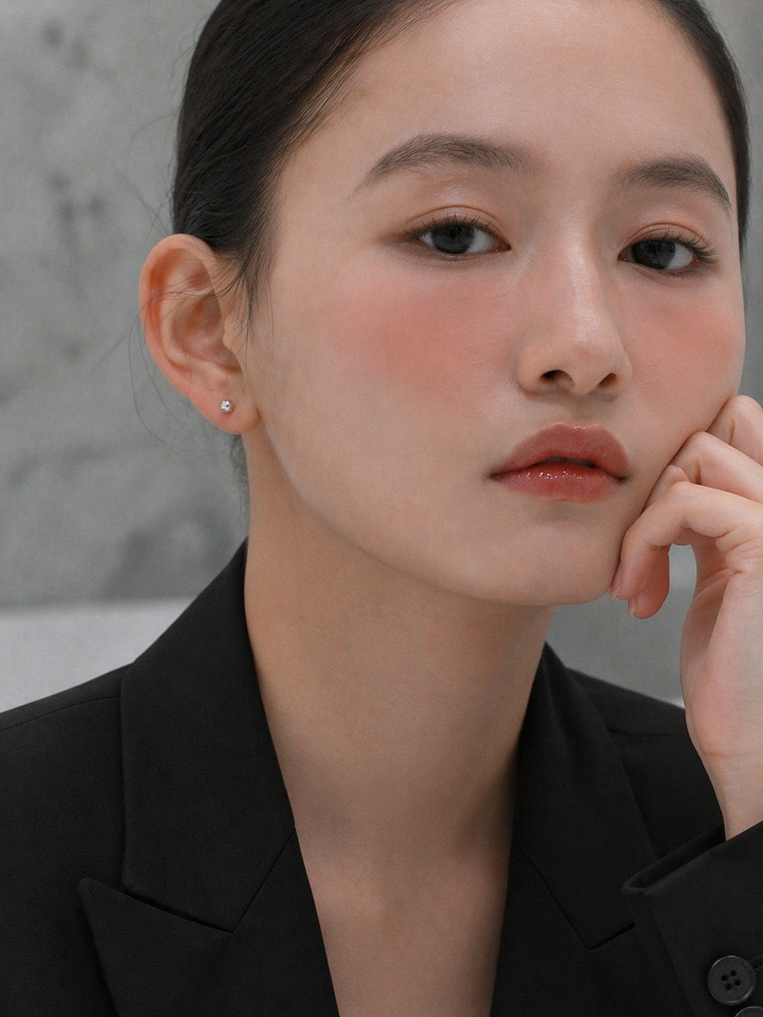 Model wearing Becky screwback earrings from myEdzy in a minimal setting