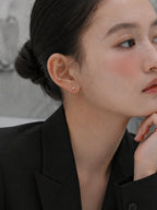 Model wearing Becky screwback earrings from myEdzy in a minimal setting