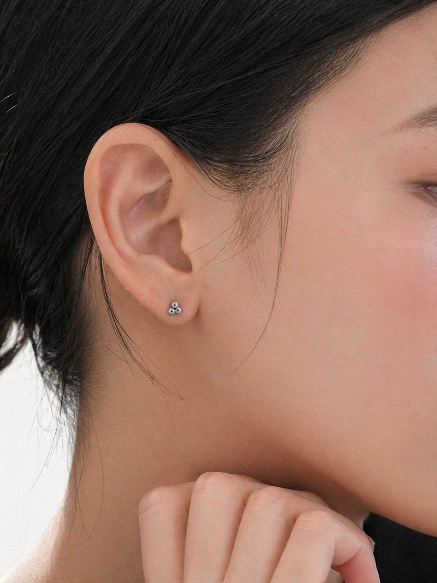 18k gold plated screwback stud earrings tiny triple cluster dainty hypoallergenic minimal everyday jewelry on ear close up | myEdzy