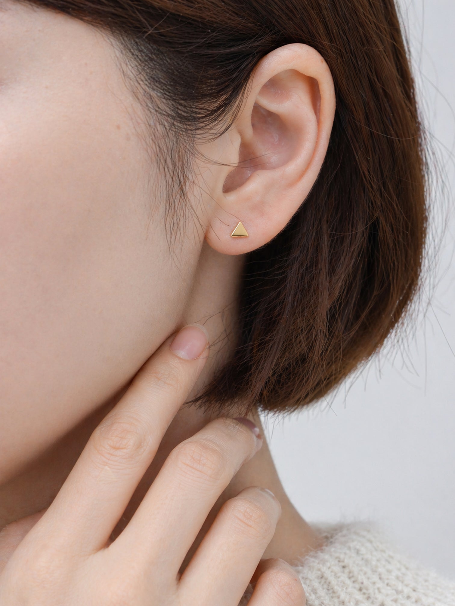 18k gold triangle stud earrings screwback minimalist geometric dainty hypoallergenic everyday jewelry myEdzy close up ear