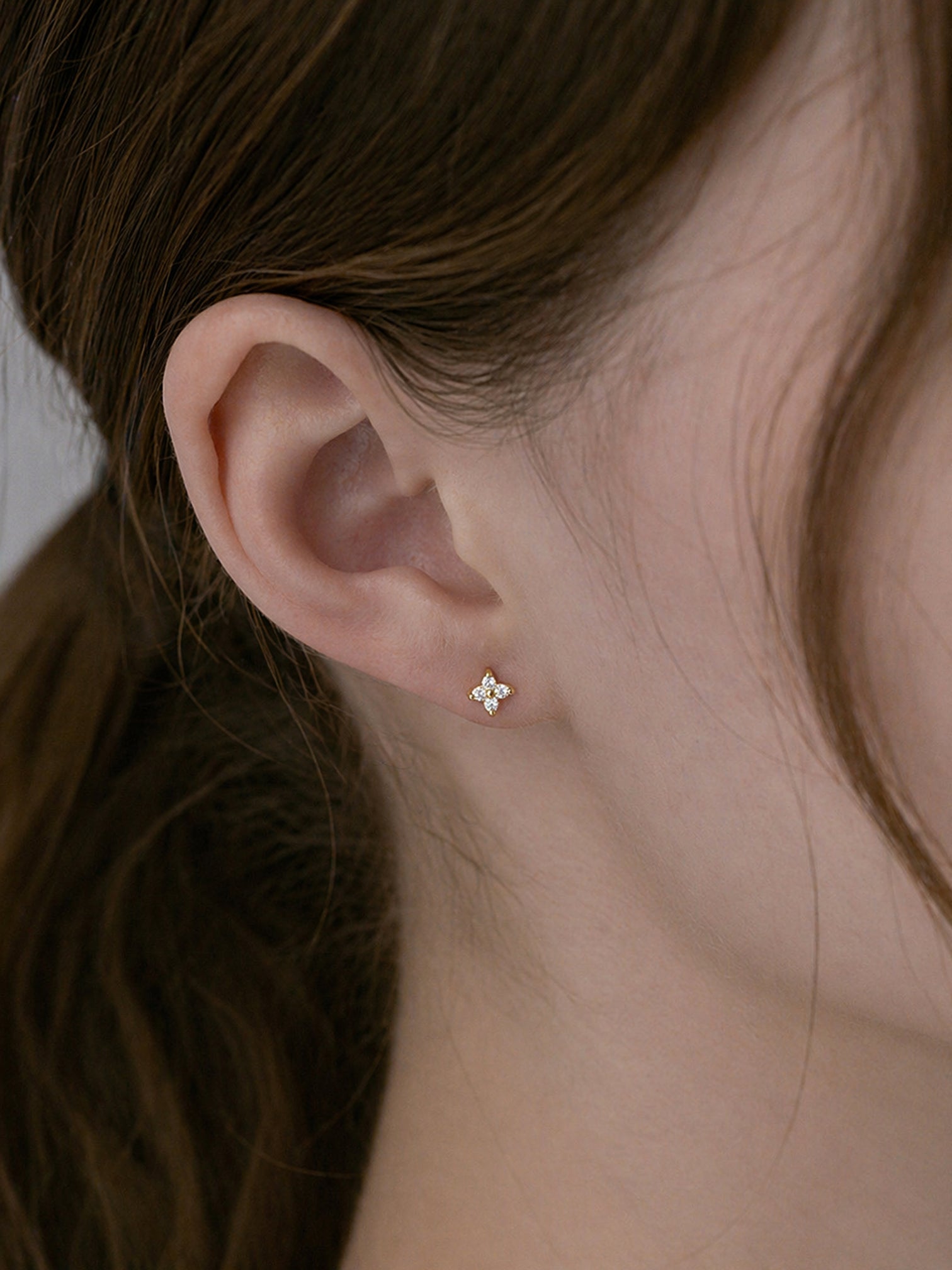 18k gold plated cz screwback stud earrings tiny flower cluster dainty minimalist hypoallergenic earrings close up ear everyday jewelry myEdzy