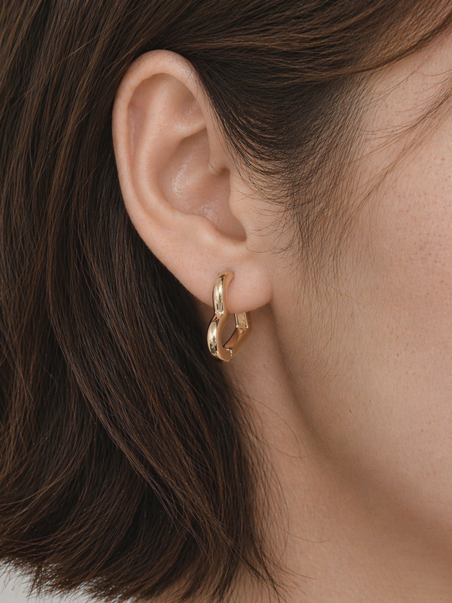 18k gold heart huggie hoop earrings close up polished finish minimal chic romantic style hypoallergenic waterproof tarnish resistant myEdzy detail shot