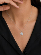 Model wearing myEdzy vintage coin pendant necklace in silver titanium steel, minimalist waterproof tarnish-resistant jewelry for women