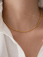 dainty gold oval bead chain necklace on neck minimal jewelry styling