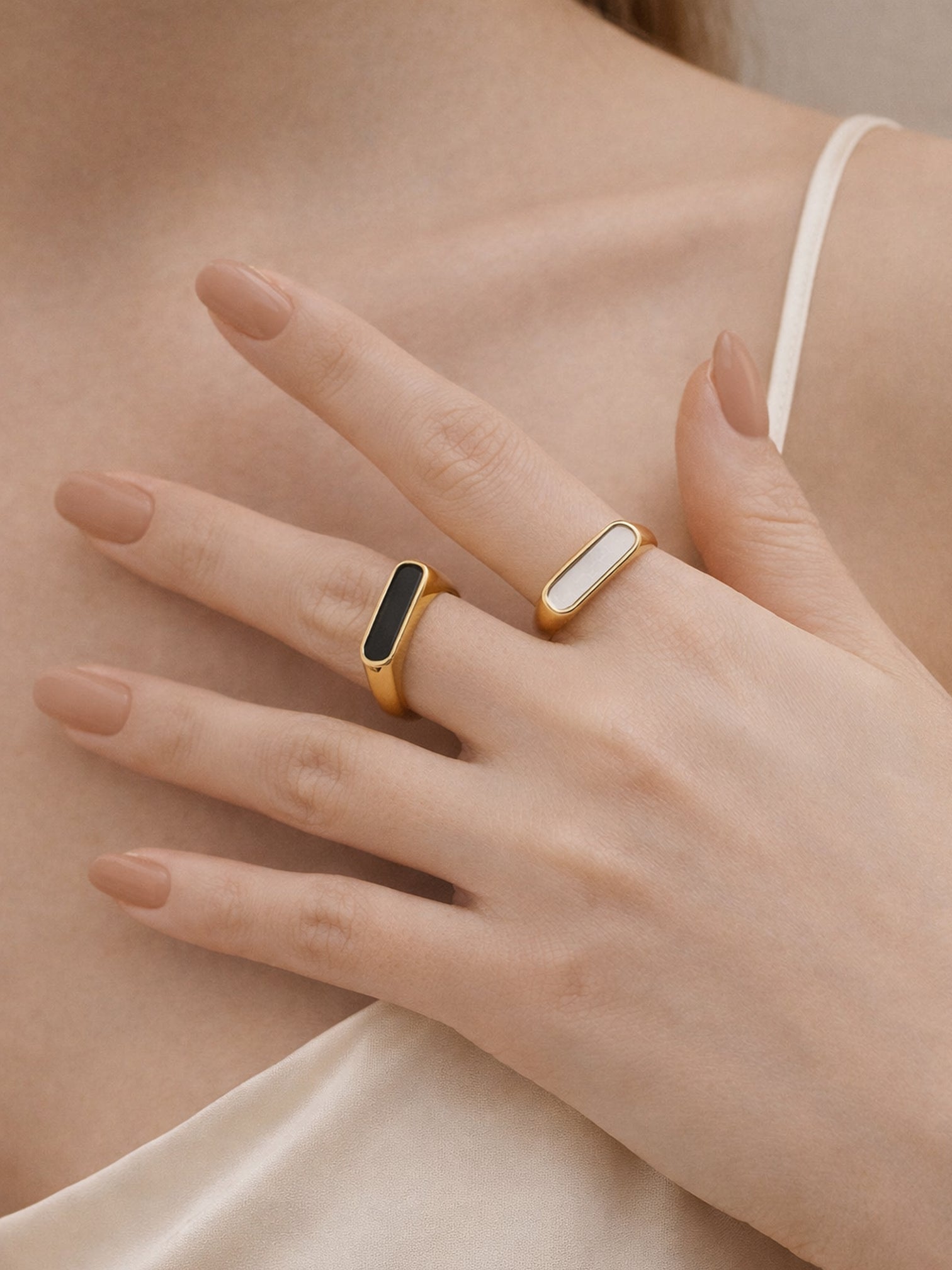 18K gold plated black onyx and white mother of peal signet statement rings worn on hand, modern minimal layered styling by myEdzy