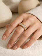 Marquise cut cubic zirconia eternity ring on finger, 18k gold plated band, dainty stacked ring, minimalist luxury jewelry, close-up hand shot, neutral beige aesthetic | myEdzy