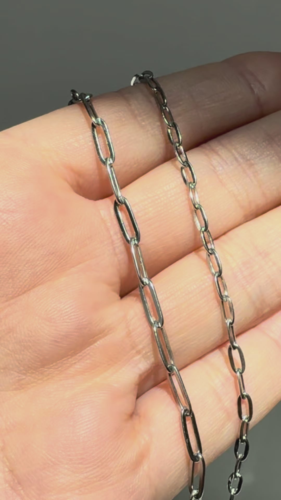 Short video comparing two Eden silver paperclip chain necklaces in different link sizes, shown on hand for scale and detail.