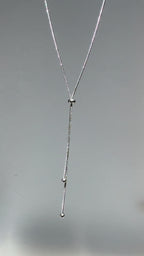 Short looping video of a silver adjustable Y lariat necklace gently swaying and catching light, with the name “Arlena” appearing on screen.
